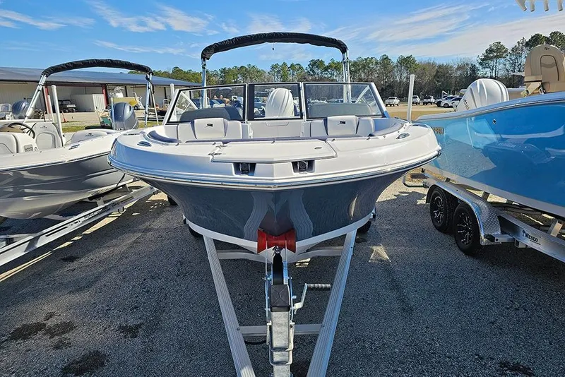 Slide: The Image of 2026 Stingray 20 SBX boat on trailer, displayed outdoors under clear sky. - 5