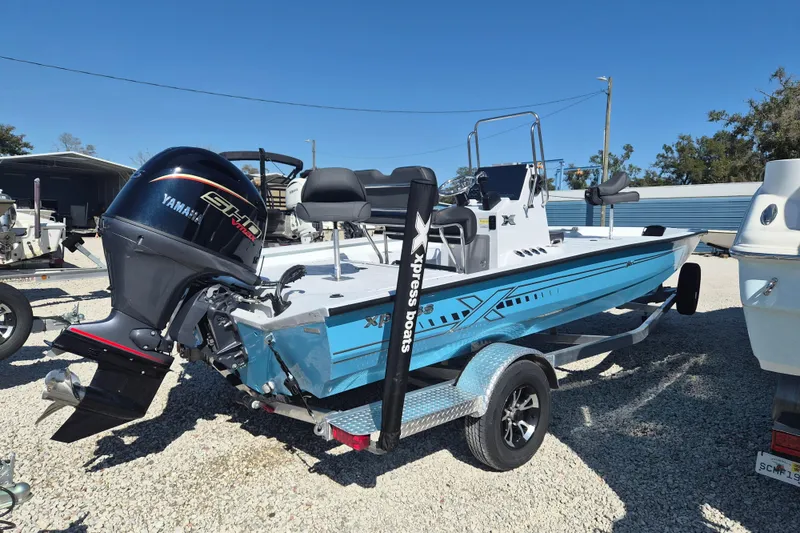The Image of 2026 Xpress H20B Bay boat with Yamaha engine on trailer, parked outdoors. - 1