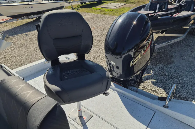 Slide: The Image of 2026 Xpress H20B Bay boat with Yamaha outboard motor and comfortable seating. - 11