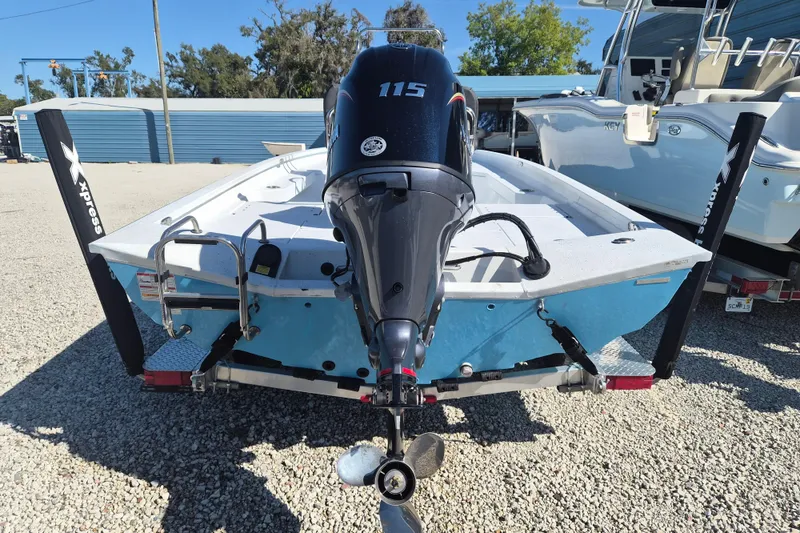 Slide: The Image of 2026 Xpress H20B Bay boat with 115 HP motor, parked on gravel. - 4