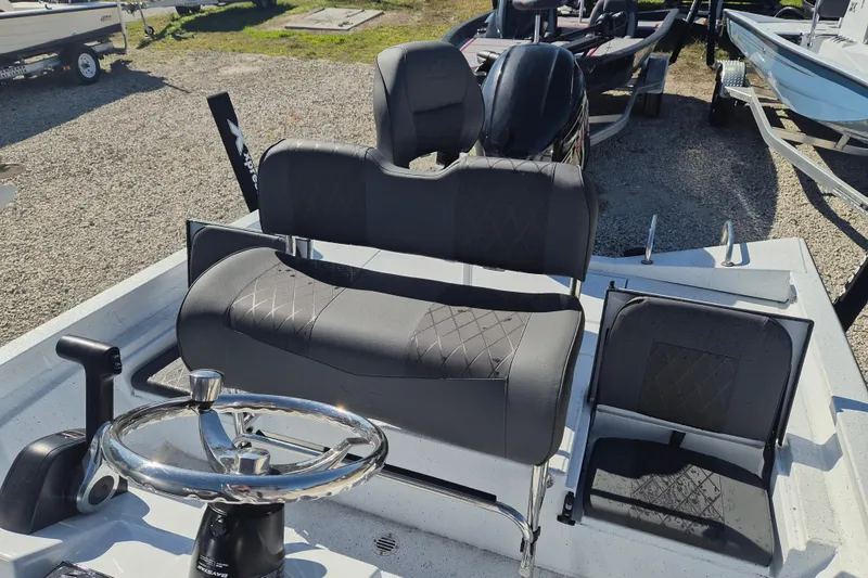 Slide: The Image of 2026 Xpress H20B Bay boat interior with steering wheel and seating. - 5