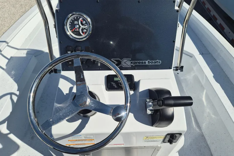 Slide: The Image of 2026 Xpress H20B Bay boat dashboard with steering wheel and controls. - 6