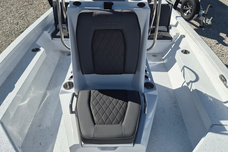 Slide: The Image of 2026 Xpress H20B Bay boat interior with cushioned seating and cup holders. - 7