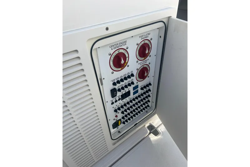 Slide: The Image of Control panel of a 2019 Pursuit S 368 Sport boat, featuring engine and electronics switches. - 26