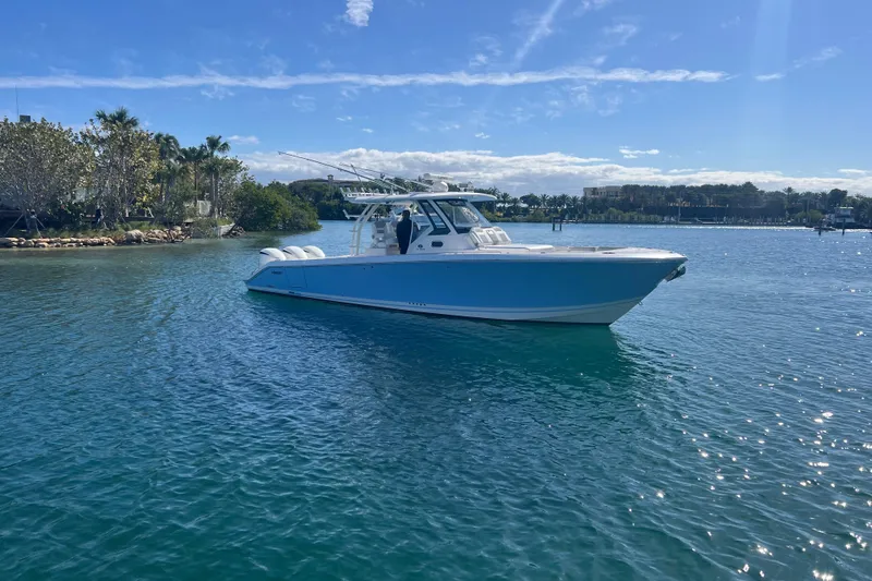 Slide: The Image of 2019 Pursuit S 368 Sport boat on clear blue water under sunny sky. - 3
