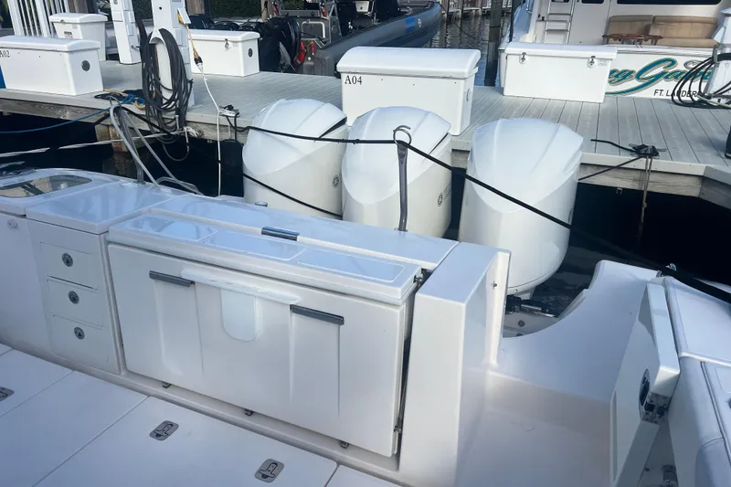 Slide: The Image of 2019 Pursuit S 368 Sport boat with triple outboard engines docked at marina. - 32