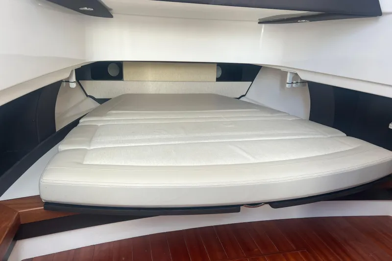 Slide: The Image of 2019 Pursuit S 368 Sport cabin interior with cushioned bed and sleek design. - 38