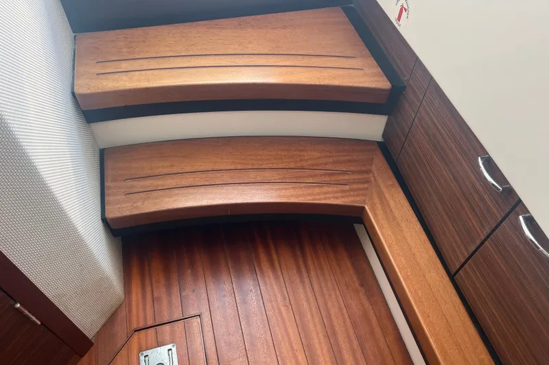 Slide: The Image of 2019 Pursuit S 368 Sport interior with wooden steps and cabinetry. - 39