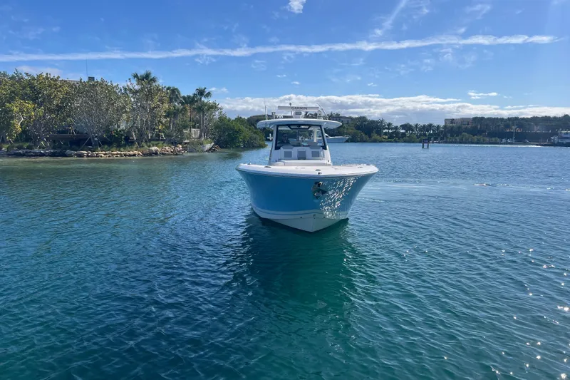Slide: The Image of 2019 Pursuit S 368 Sport boat on clear blue water under a sunny sky. - 4