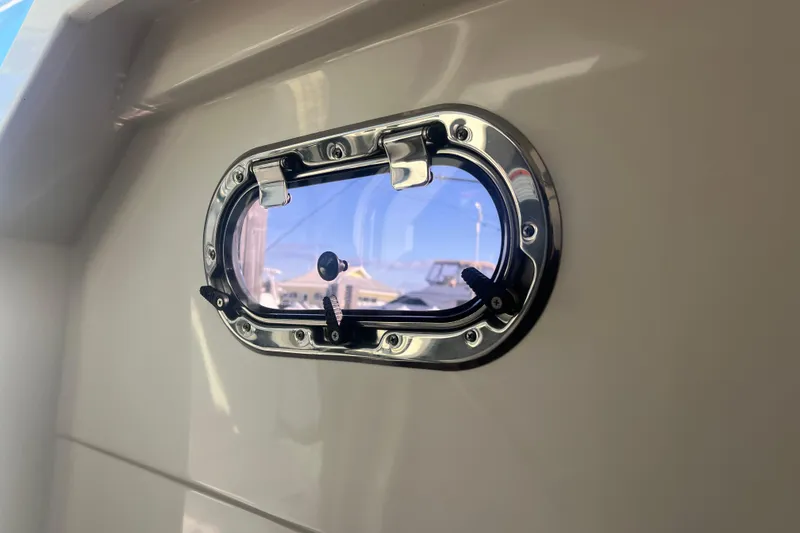 Slide: The Image of 2019 Pursuit S 368 Sport boat porthole with chrome finish and clear view. - 40