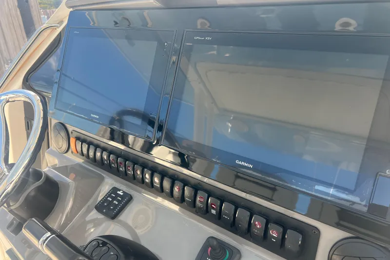 Slide: The Image of Control panel of 2019 Pursuit S 368 Sport boat with Garmin displays and switches. - 49