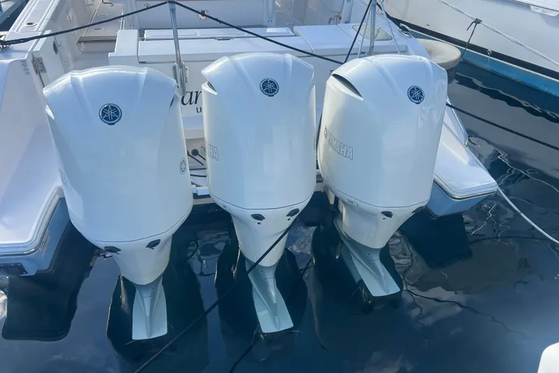 Slide: The Image of 2019 Pursuit S 368 Sport with triple Yamaha outboard engines docked in marina. - 9