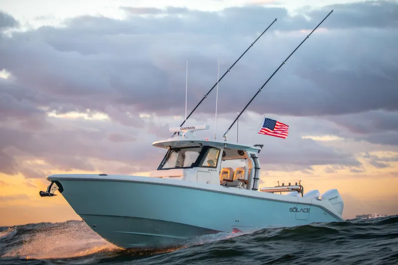 The Image of 2026 Solace 35 CS boat cruising at sunset with American flag. - 1