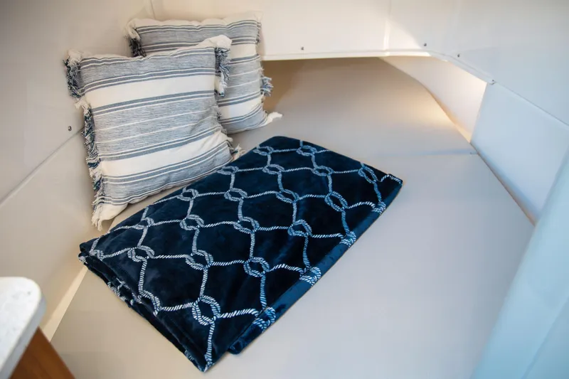 Slide: The Image of Cozy cabin interior of 2026 Solace 35 CS with pillows and blanket. - 6