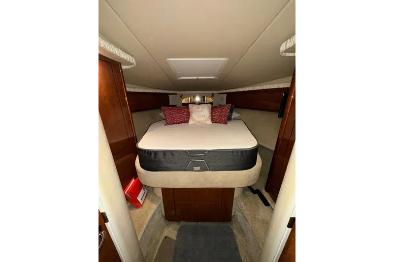Slide: The Image of Interior cabin of 2003 Sea Ray 420 Sundancer with cozy bed and pillows. - 12