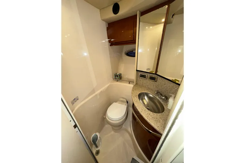 Slide: The Image of 2003 Sea Ray 420 Sundancer yacht bathroom with sink, toilet, and mirror. - 14