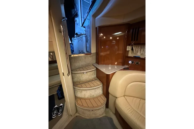 Slide: The Image of Interior of 2003 Sea Ray 420 Sundancer yacht with curved stairs and leather seating. - 15