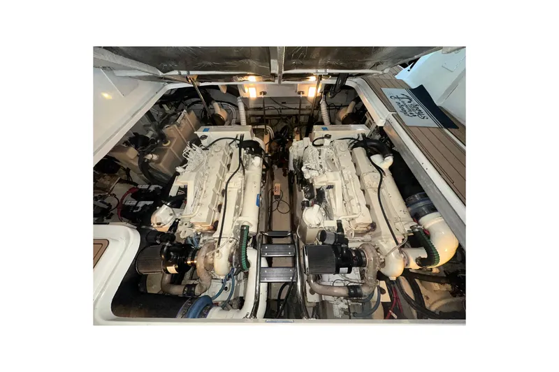 Slide: The Image of Engine room of 2003 Sea Ray 420 Sundancer with dual engines and mechanical components. - 17