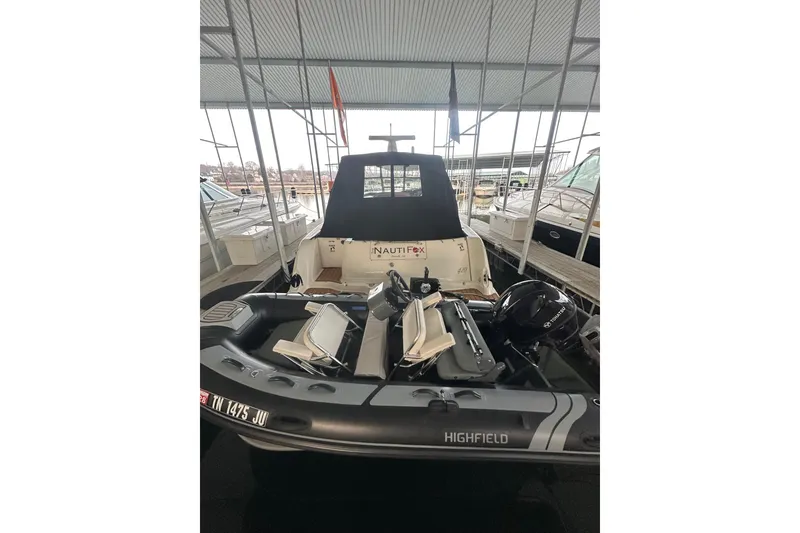 Slide: The Image of 2003 Sea Ray 420 Sundancer docked with inflatable boat, covered in marina. - 20