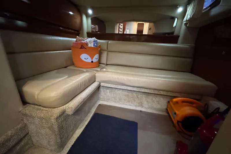 Slide: The Image of Interior of 2003 Sea Ray 420 Sundancer with beige seating and cozy decor. - 3