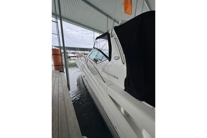 Slide: The Image of 2003 Sea Ray 420 Sundancer docked under a covered marina. - 6