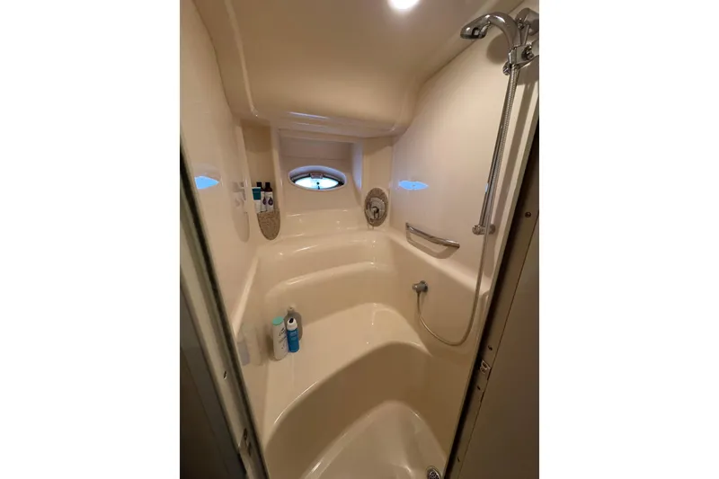 Slide: The Image of Shower area in 2003 Sea Ray 420 Sundancer yacht with porthole and toiletries. - 8