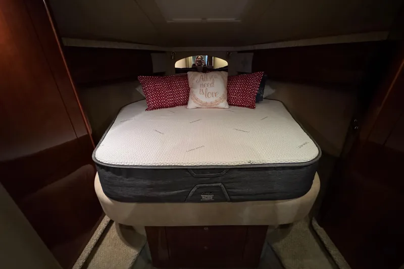 Slide: The Image of Luxurious cabin interior of 2003 Sea Ray 420 Sundancer with cozy bed and decorative pillows. - 9