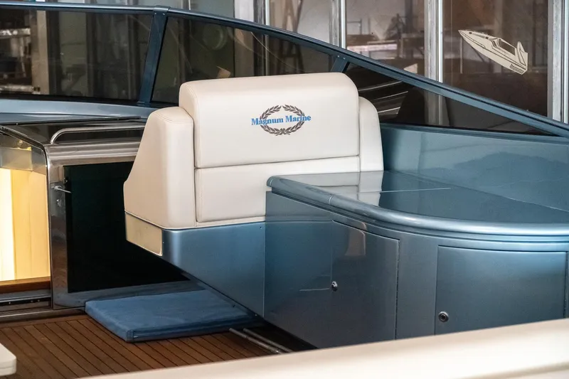 Slide: The Image of Interior of a 1997 Magnum 56 yacht with white seating and sleek design. - 18