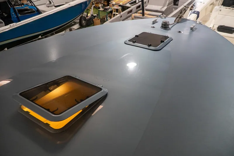 Slide: The Image of 1997 Magnum 56 yacht deck with open hatches in a boatyard setting. - 22