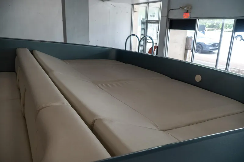 Slide: The Image of Interior of a 1997 Magnum 56 boat with beige seating and modern design. - 28