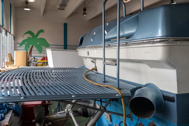 Slide: The Image of 1997 Magnum 56 boat in a garage with tropical decor and maintenance equipment. - 34