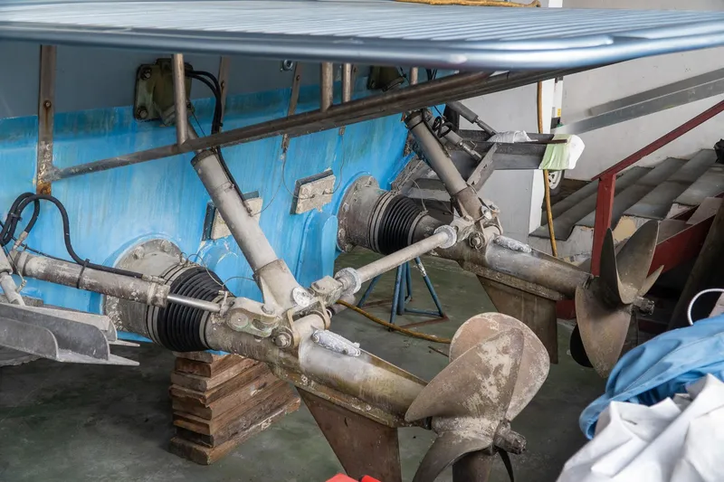 Slide: The Image of Close-up of a 1997 Magnum 56 boat propellers and drive system in a workshop. - 35