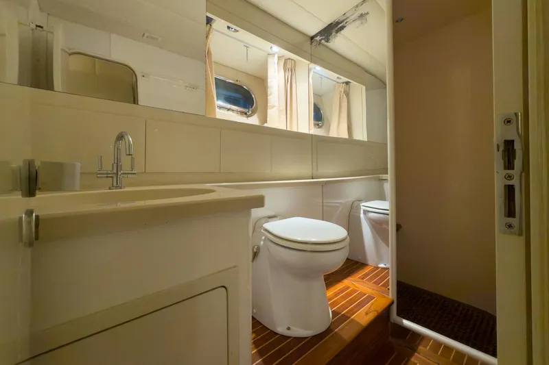 Slide: The Image of Luxurious yacht bathroom with wooden flooring, mirror, and modern fixtures, Magnum 56, 1997 model. - 41