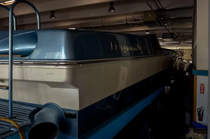 Slide: The Image of 1997 Magnum 56 yacht in storage, showcasing sleek design and blue-white color scheme. - 43