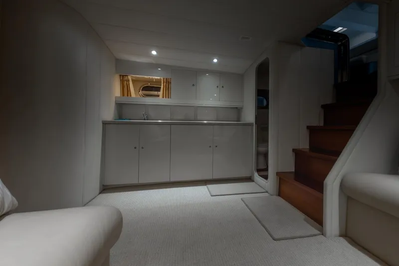 Slide: The Image of Interior of a 1997 Magnum 56 yacht with modern cabinetry and wooden stairs. - 46