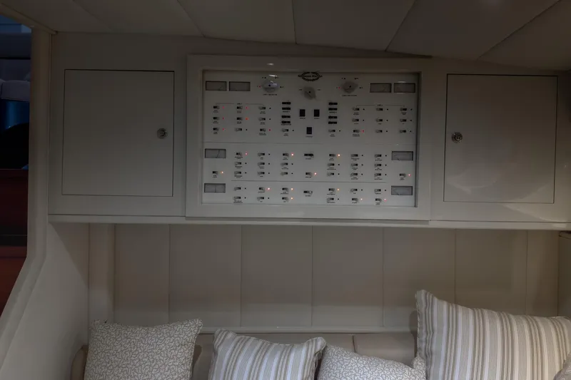 Slide: The Image of Control panel inside a 1997 Magnum 56 yacht, featuring switches and indicators. - 47