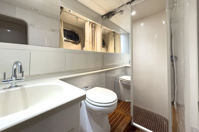 Slide: The Image of Luxurious bathroom in 1997 Magnum 56 yacht with modern fixtures and wooden flooring. - 50