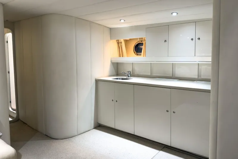 Slide: The Image of Luxurious interior of 1997 Magnum 56 yacht with sleek white cabinetry and modern lighting. - 53
