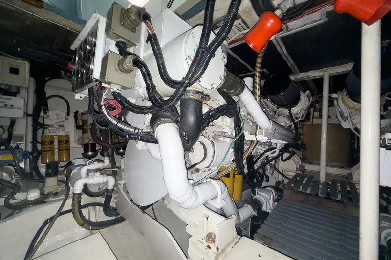 Slide: The Image of Engine room of a 1997 Magnum 56 yacht, showcasing complex machinery and wiring. - 57