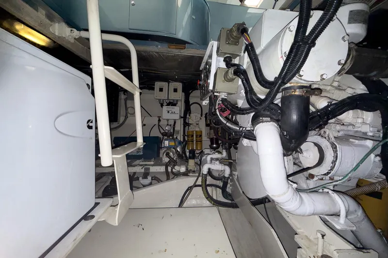Slide: The Image of Engine room of a 1997 Magnum 56 yacht, showcasing complex machinery and wiring. - 58