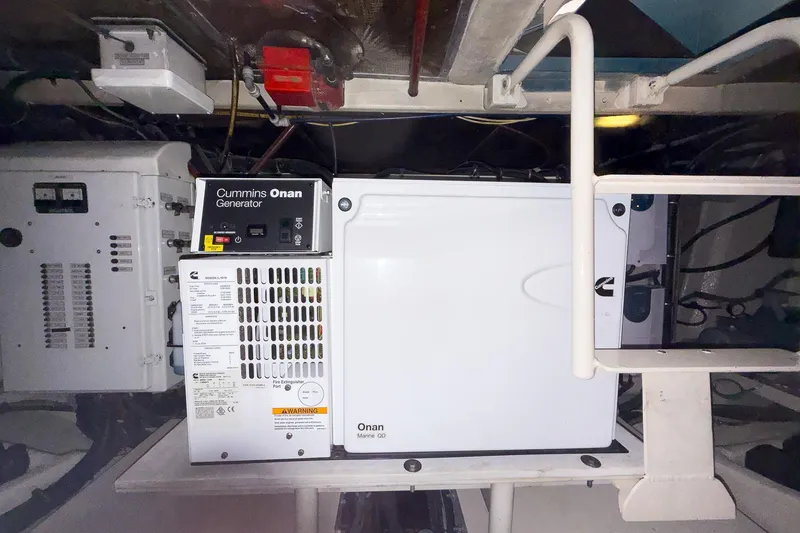 Slide: The Image of Cummins Onan generator in a Magnum 56, 1997 model, engine room setup. - 62