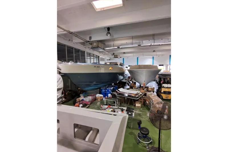 Slide: The Image of 1997 Magnum 56 boat in a storage facility with equipment and supplies. - 65