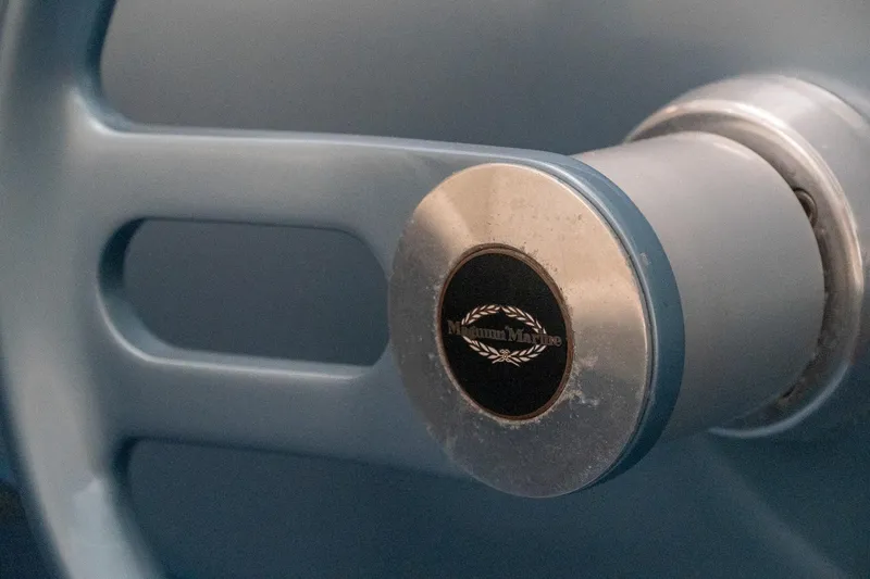 Slide: The Image of Close-up of a 1997 Magnum 56 steering wheel with logo detail. - 7