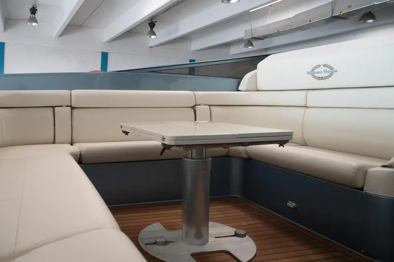 Slide: The Image of Luxurious interior of a 1997 Magnum 56 yacht with elegant seating and table. - 9