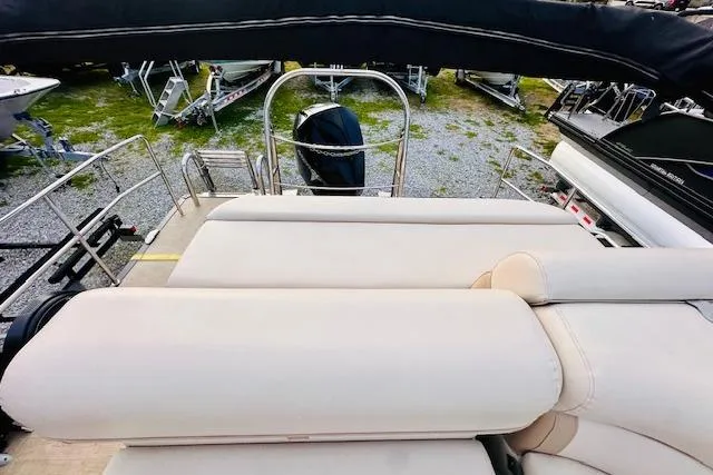 Slide: The Image of 2019 Harris Cruiser 250 pontoon boat with beige seating and cup holders. - 10