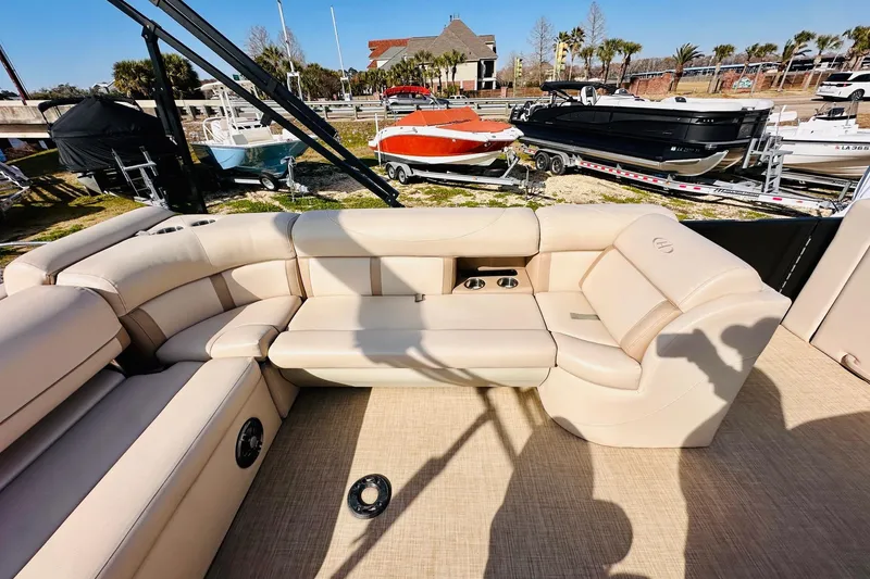 Slide: The Image of Luxurious seating on 2019 Harris Cruiser 250 boat, with cup holders and beige upholstery. - 15
