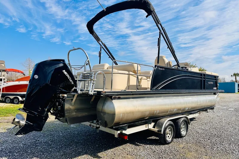 Slide: The Image of 2019 Harris Cruiser 250 pontoon boat on trailer with Mercury outboard motor. - 3