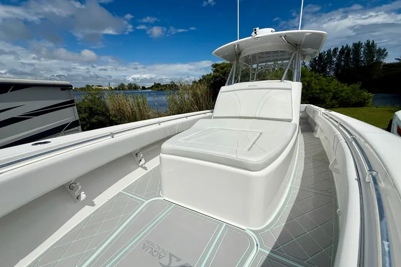 Slide: The Image of 2023 Contender 39 Fisharound boat with sleek design, spacious deck, and comfortable seating. - 13
