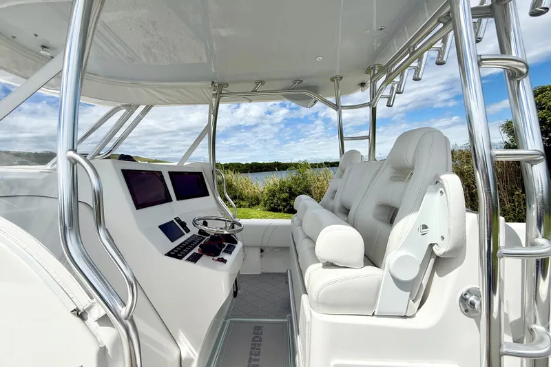 Slide: The Image of 2023 Contender 39 Fisharound boat interior with sleek helm and comfortable seating. - 6