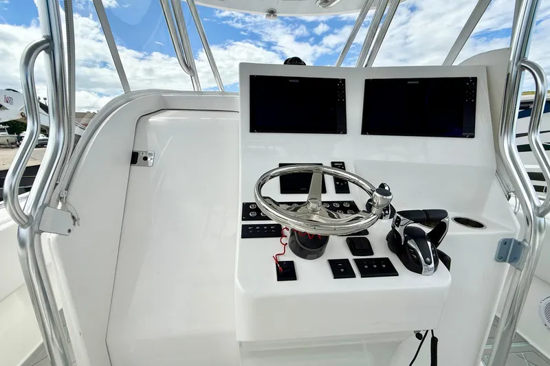 Slide: The Image of 2023 Contender 39 Fisharound helm with dual displays and modern controls. - 7